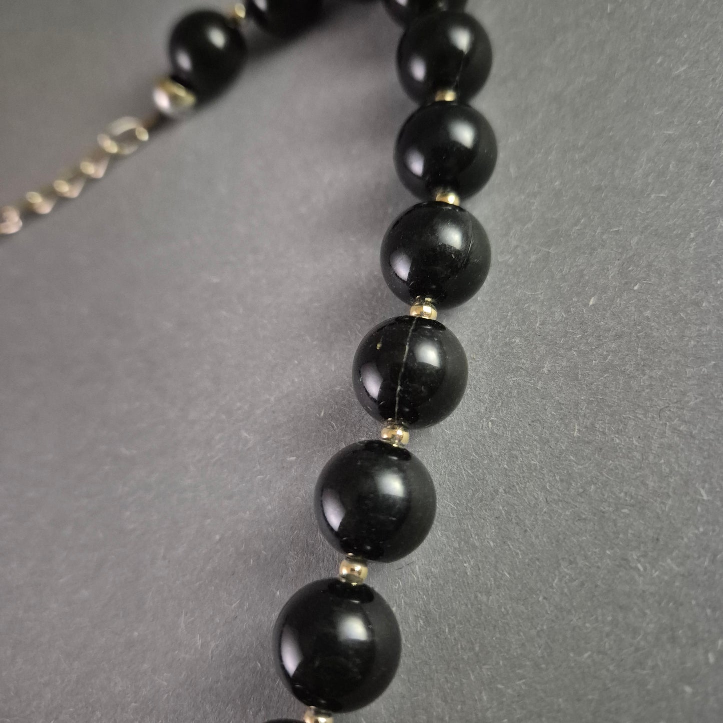 Klassische Perlenkette – Elegante schwarze Kugelperlen mit Goldakzenten