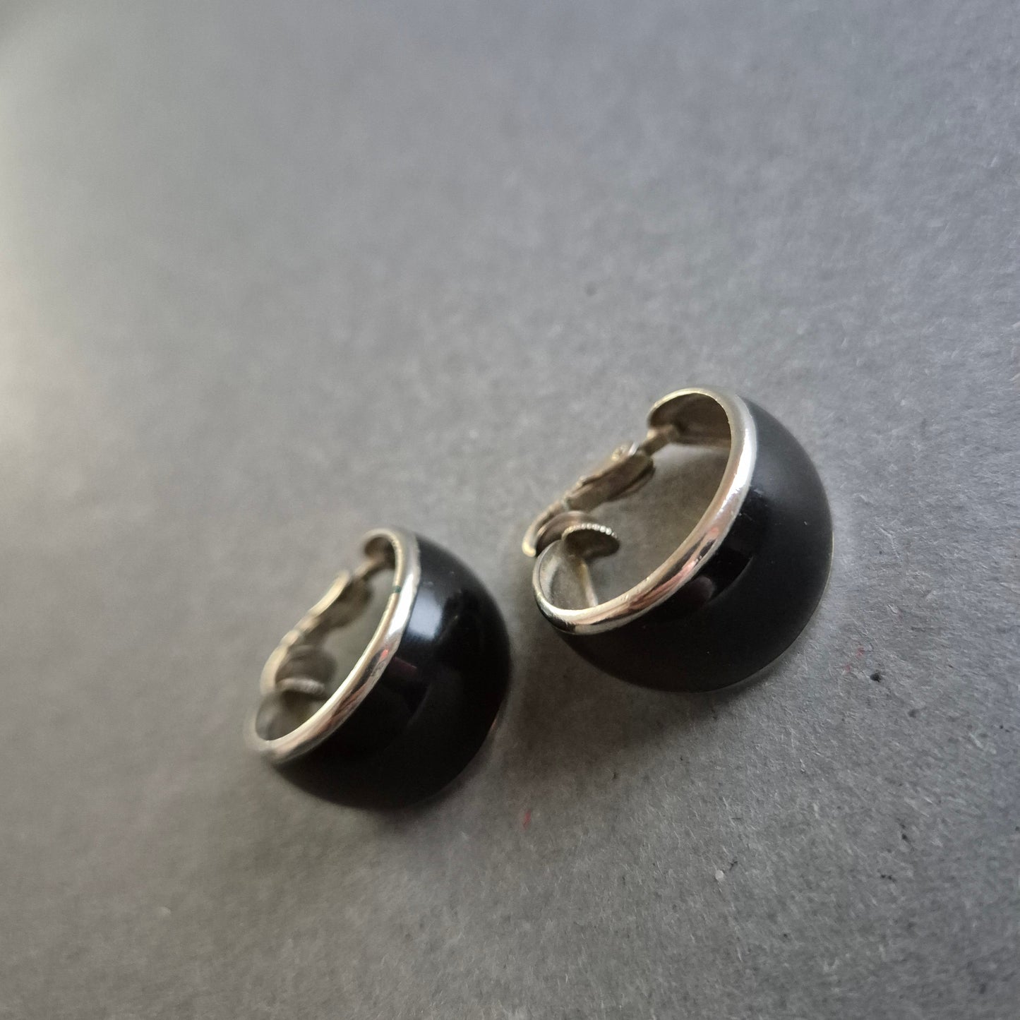 Klassische schwarze Clip-Ohrringe mit silberfarbenem Rand