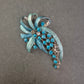 Vintage-Brosche mit türkisfarbenen Strasssteinen und Emailleblättern