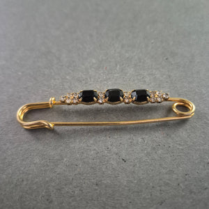 Elegante goldene Brosche – Sicherheitsnadel mit schwarzen Ziersteinen