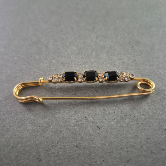 Elegante goldene Brosche – Sicherheitsnadel mit schwarzen Ziersteinen