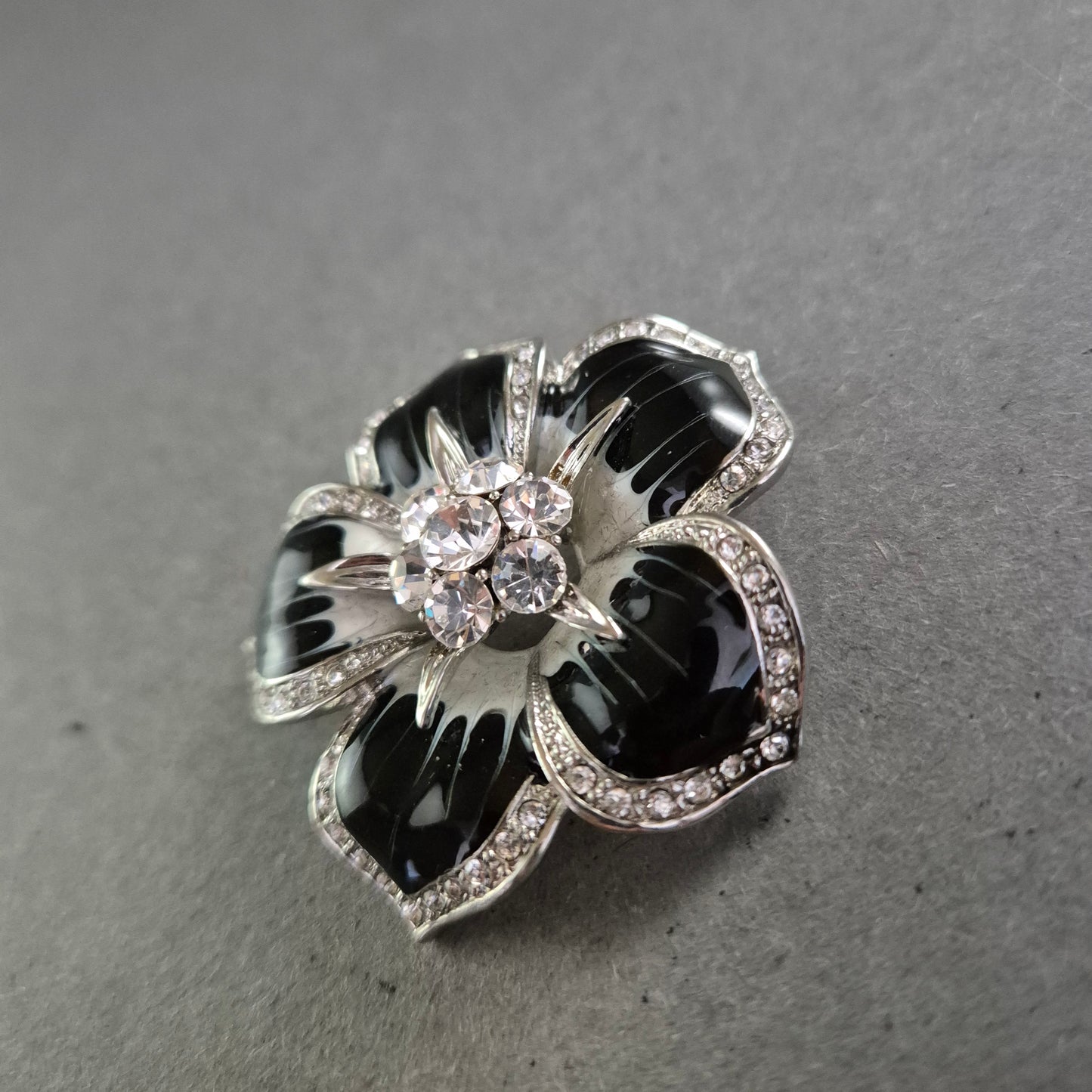 Brosche in Blütenform mit Strass und schwarzer Emaille – Glamourös
