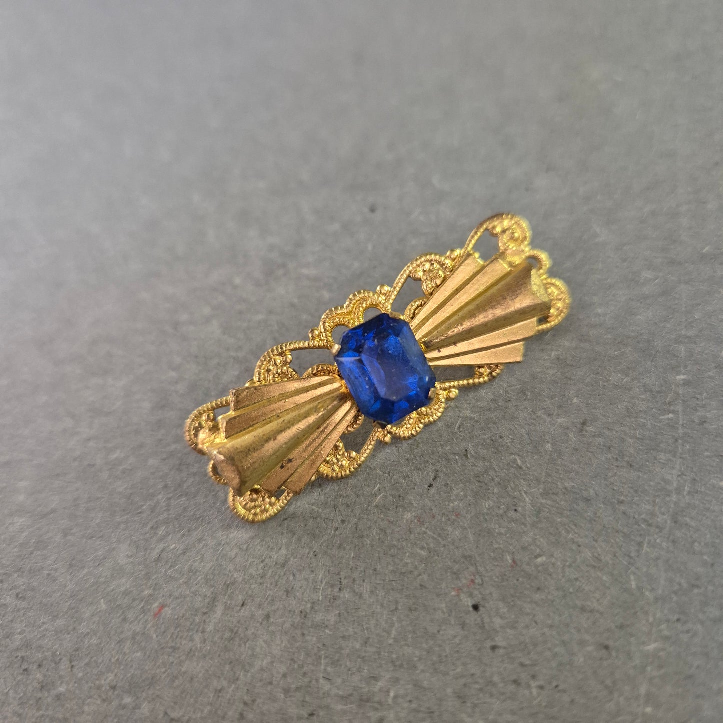 Goldfarbene Vintage-Brosche mit blauem Stein – Filigrane Eleganz