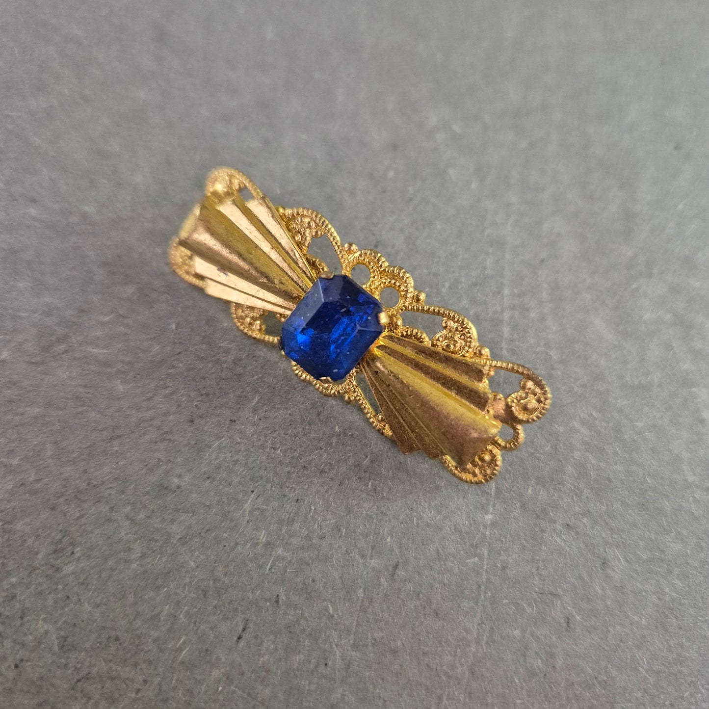 Goldfarbene Vintage-Brosche mit blauem Stein – Filigrane Eleganz