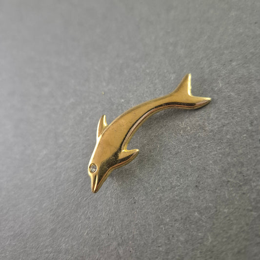 Goldfarbene Delfin-Brosche mit Strassstein als Auge