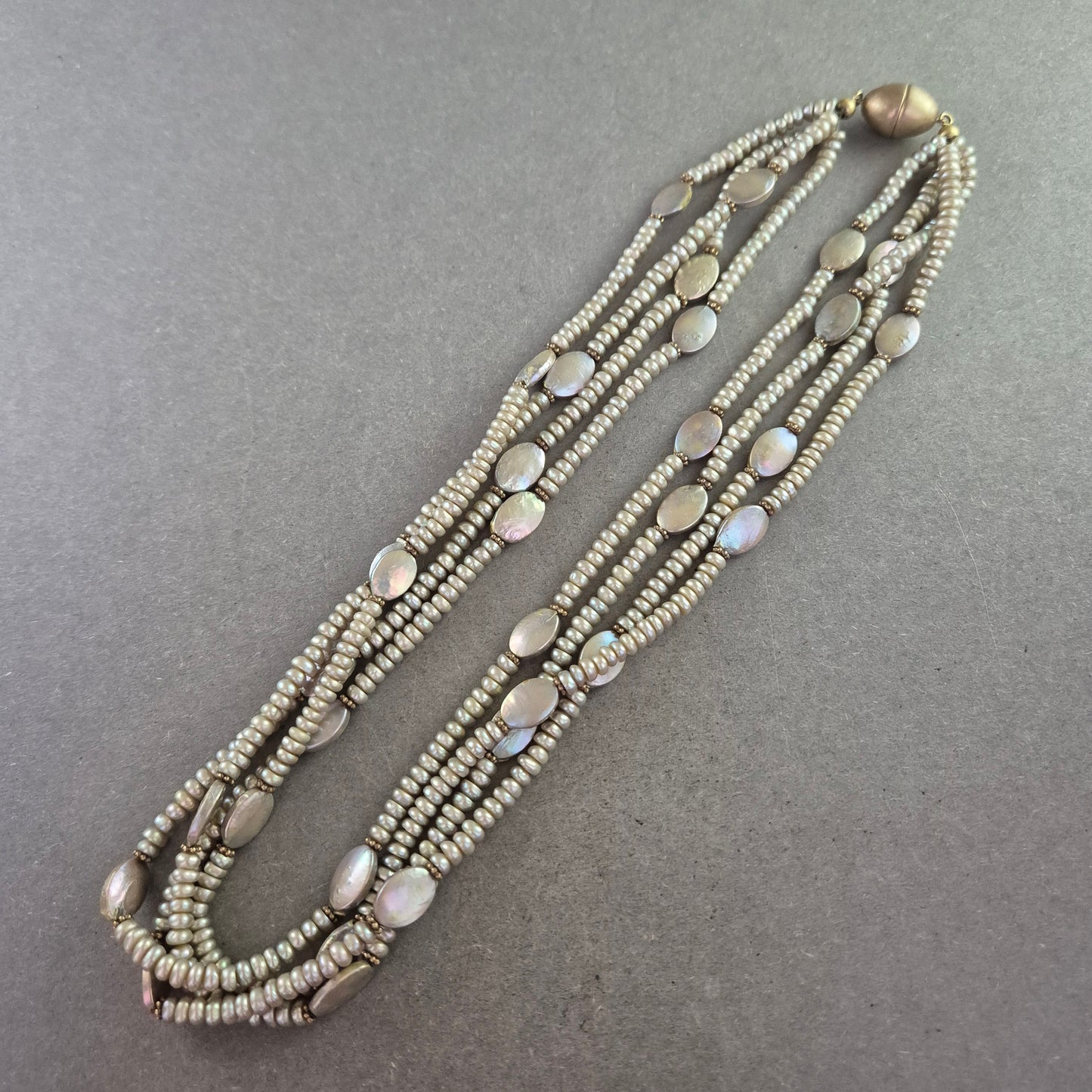 Mehrreihige Halskette mit schimmernden Perlen in Grau