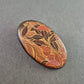 Ovalbrosche im Retro-Look mit floraler Musterung in Braun-Orange