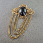 Antike Brosche im Barockstil – Schwarzer Cabochon & Kettendekor