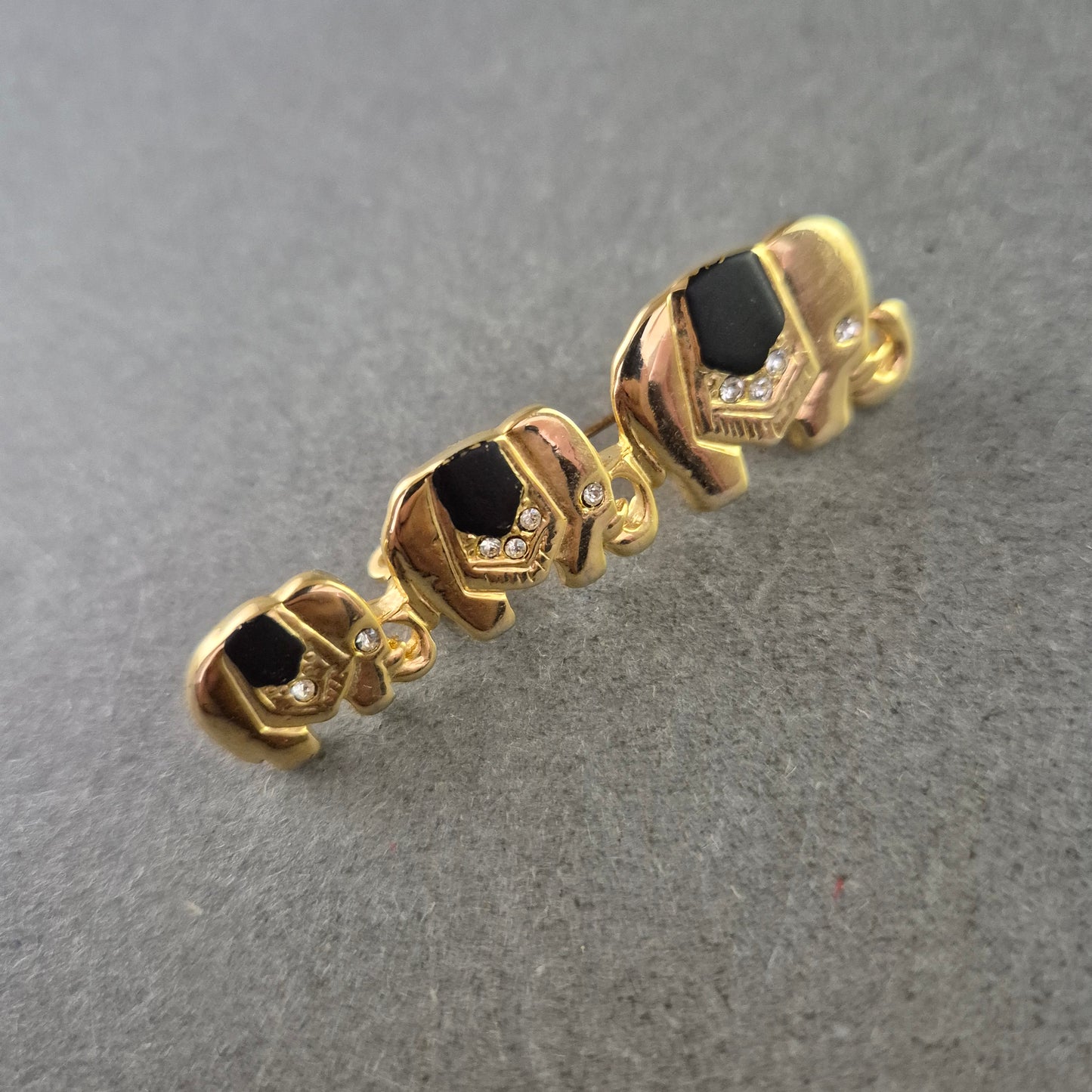 Vintage Brosche Elefantenreihe – Goldfarben, Schwarz & Strass