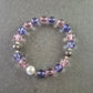 Elastisches Armband mit rosa und violetten Glasperlen