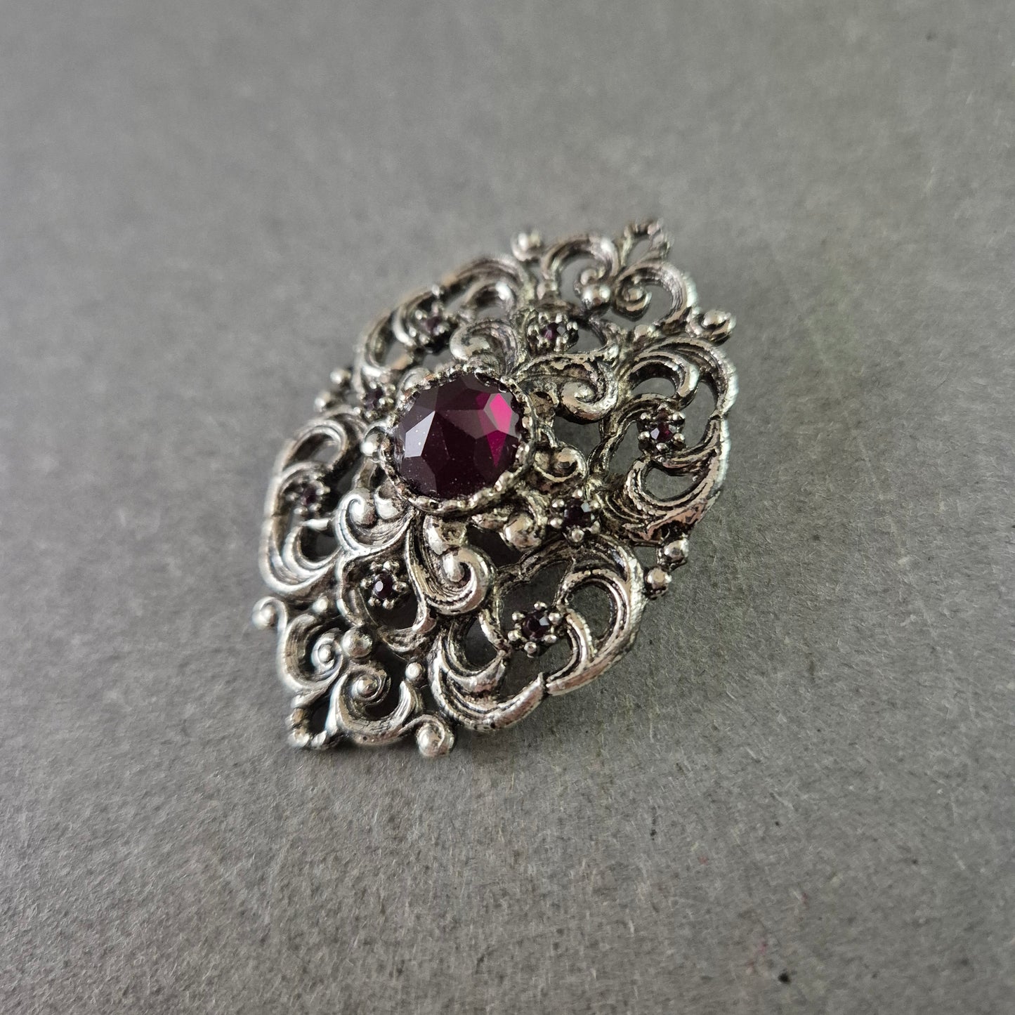 Antike Brosche im Barockstil – Silberfarben mit rotem Schmuckstein