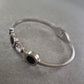 Elegantes Armreif Armband mit Kristallen und schwarzem Inlay