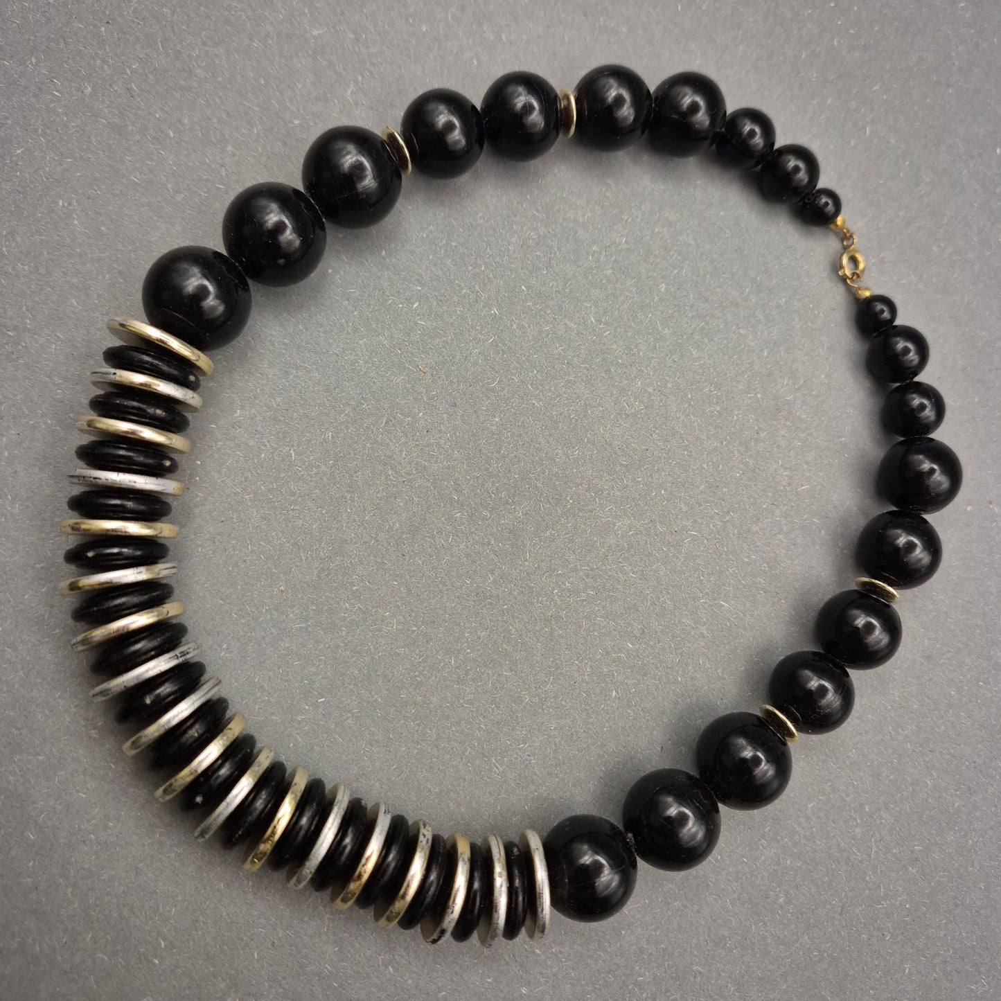 Elegante Halskette mit schwarzen Perlen und Metallscheiben