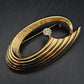 Elegante Goldene Brosche mit Kristall – Modernes Geschwungenes Design