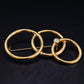 Elegante Brosche mit ineinandergreifenden Ringen – Goldfarbenes Vintage Design