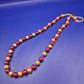 Elegante Damen Perlen Kette in Rot und Gold – Stilvolles Design