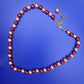 Elegante Vintage Perlenkette in Weinrot und Creme mit Goldton