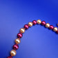 Elegante Vintage Perlenkette in Weinrot und Creme mit Goldton