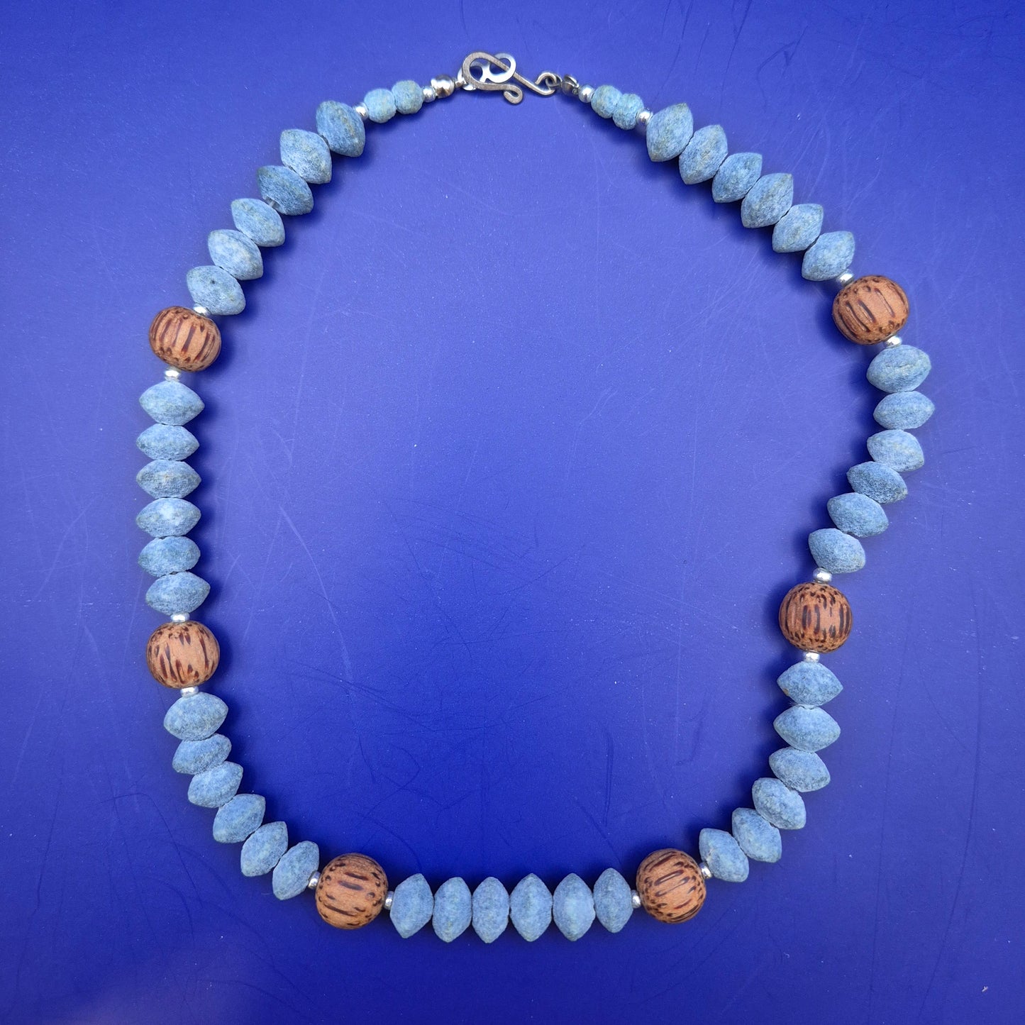 Handgefertigte Kette aus blauen Holzperlen und Kokosnuss-Elementen