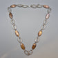 Vintage Kette mit ovalen Elementen in braunem Perlmutt-Look und silbernen Gliedern