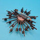 Vintage Starburst Brosche mit roten Strasssteinen in dunklem Metall