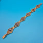 Antikes Gliederarmband mit Granatsteinen in goldfarbenem Filigran-Design