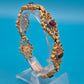 Antikes Gliederarmband mit Granatsteinen in goldfarbenem Filigran-Design