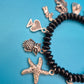 Verspieltes Vintage Charm-Armband mit schwarzen Perlen und Anhängern