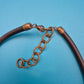 Vintage Statement-Kette mit gehämmerten Messing-Elementen und schwarzem Band