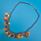 Vintage Statement-Kette mit floralen Anhängern und blauem Textilband