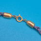 Vintage Statement-Kette mit floralen Anhängern und blauem Textilband