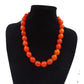 Leuchtend orangefarbene Kugelketten-Halskette mit abgestuften Perlen