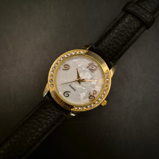 Elegante goldfarbene Damenuhr mit Strass und Perlmutt-Zifferblatt