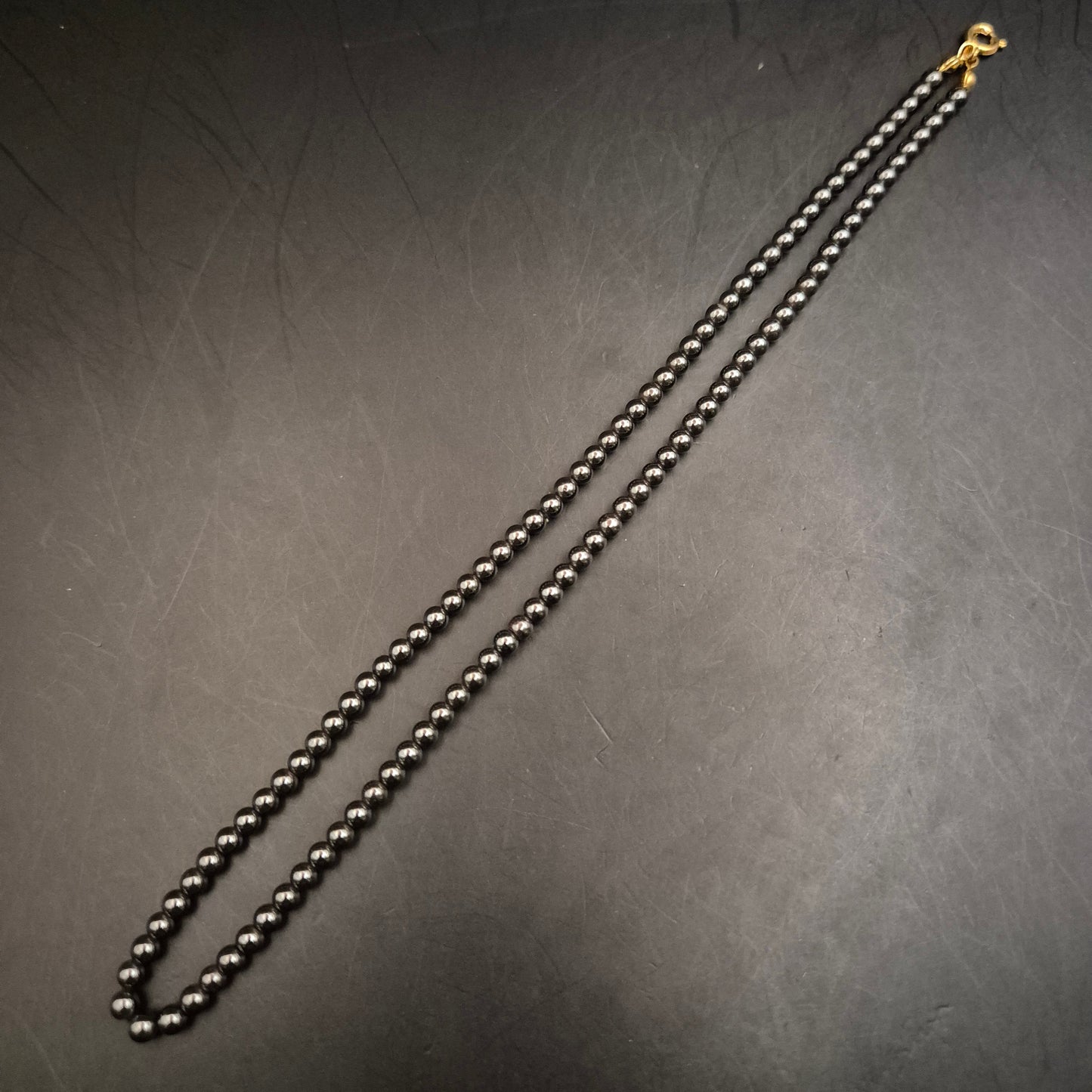 Elegante Hämatit-Perlenhalskette mit glänzendem Goldverschluss - Bild 2