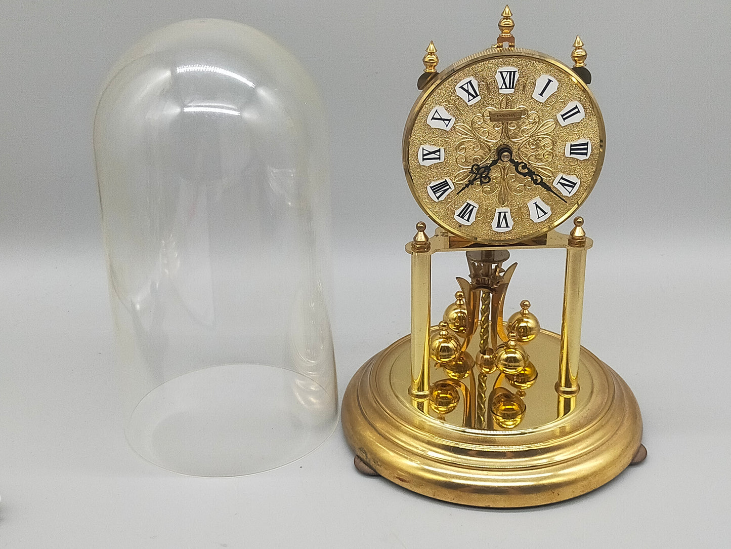 Edle Dugena Drehpendeluhr – Goldfarbenes Vintage Design unter Glaskuppel