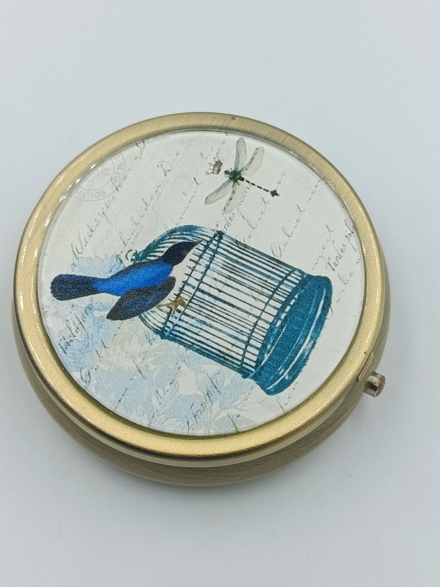 Runde Vintage-Dose mit Vogel- und Käfig-Motiv