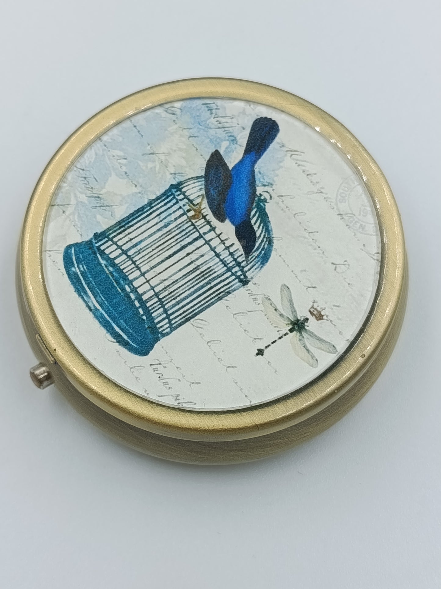 Runde Vintage-Dose mit Vogel- und Käfig-Motiv