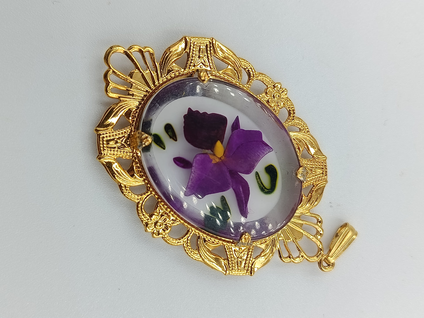 Goldfarbener Anhänger mit handbemaltem Blumenmotiv