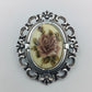 Vintage-Brosche mit Rosenmotiv im Silberrahmen