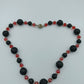 Lava-Perlenkette mit roten Kristall-Highlights