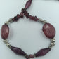 Lange Halskette in Violett mit Glassteinen & Silberdetails