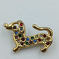 Goldfarbene Brosche „Dackel“ mit bunten Strasssteinen