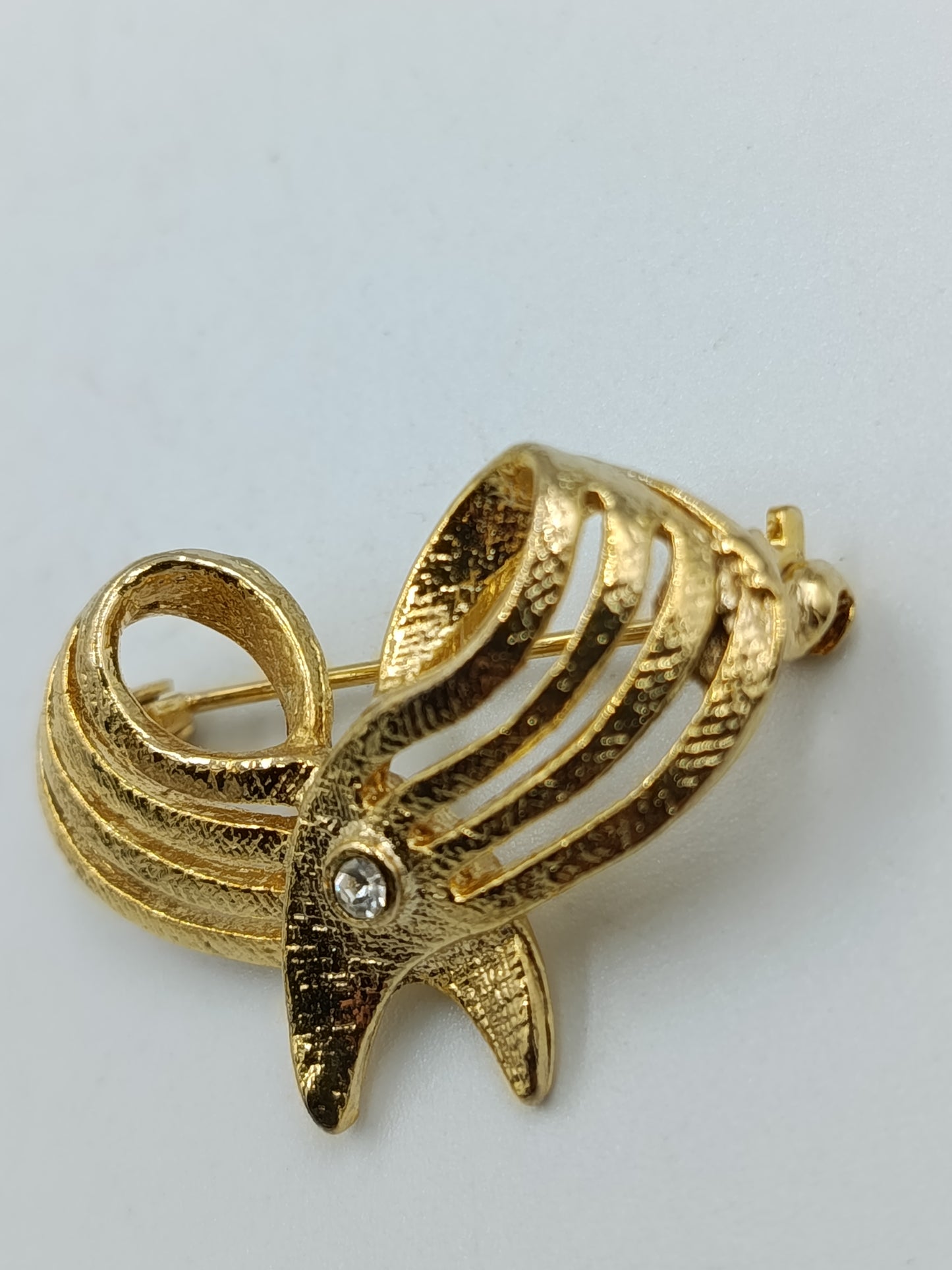 Elegante goldfarbene Brosche mit Strassakzent