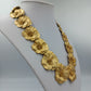 Opulente Statement Kette in Goldblüten Design