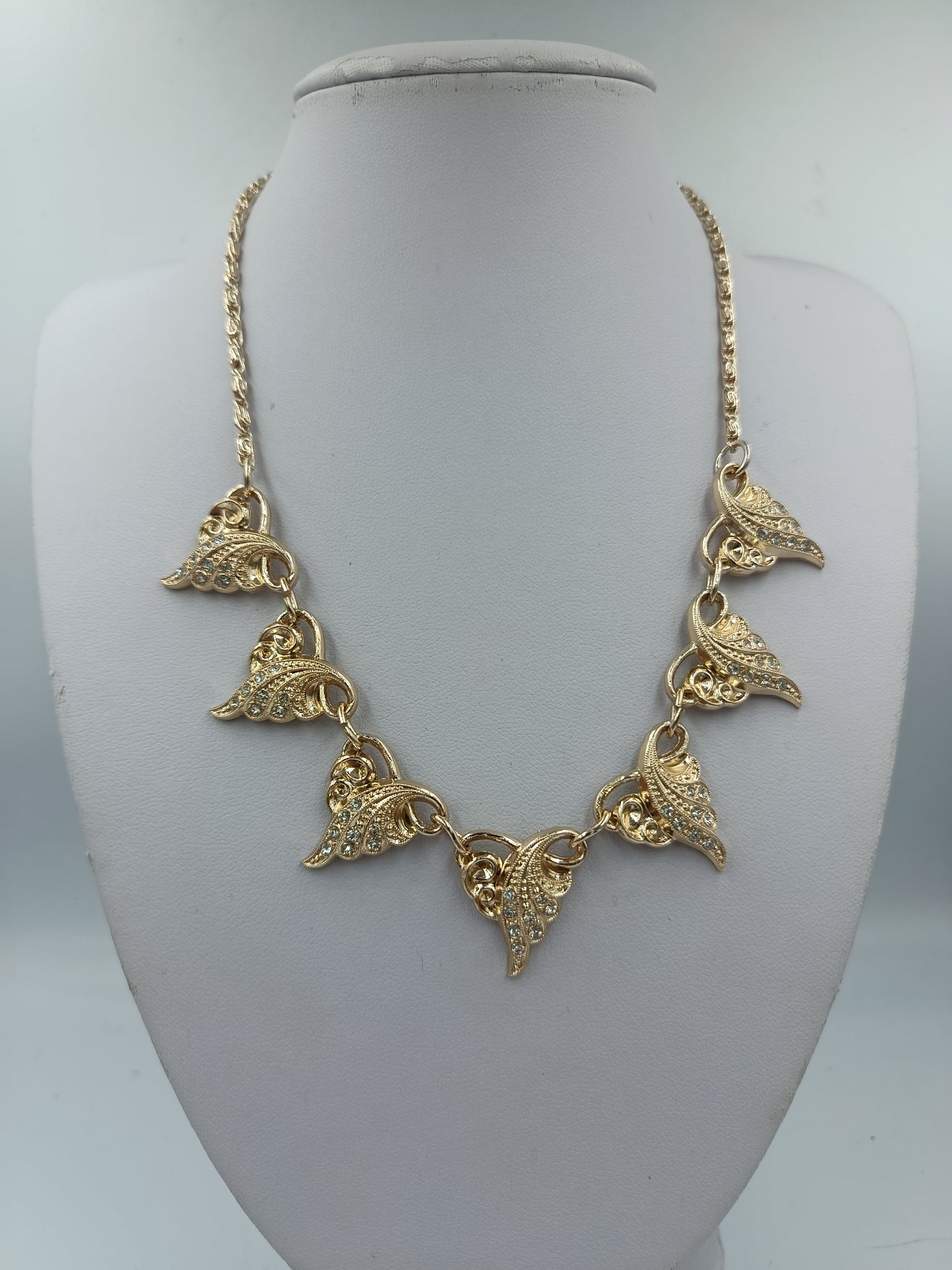 Goldfarbene Halskette mit funkelnden Blätterelementen
