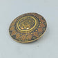 Runde goldfarbene Brosche mit orientalischem Muster