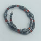 Elastisches Hämatit Armband mit roten Zierperlen