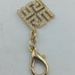 Goldfarbener Anhänger mit Strassbesatz und Karabinerhaken