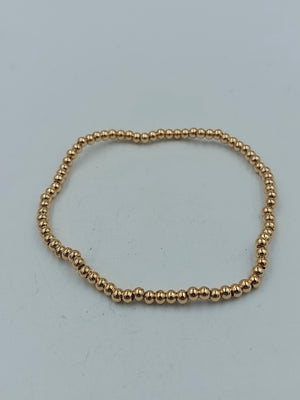 Feines elastisches Armband mit goldfarbenen Mini-Kugeln