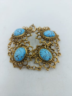Vergoldetes Armband mit vier türkisfarbenen Schmucksteinen